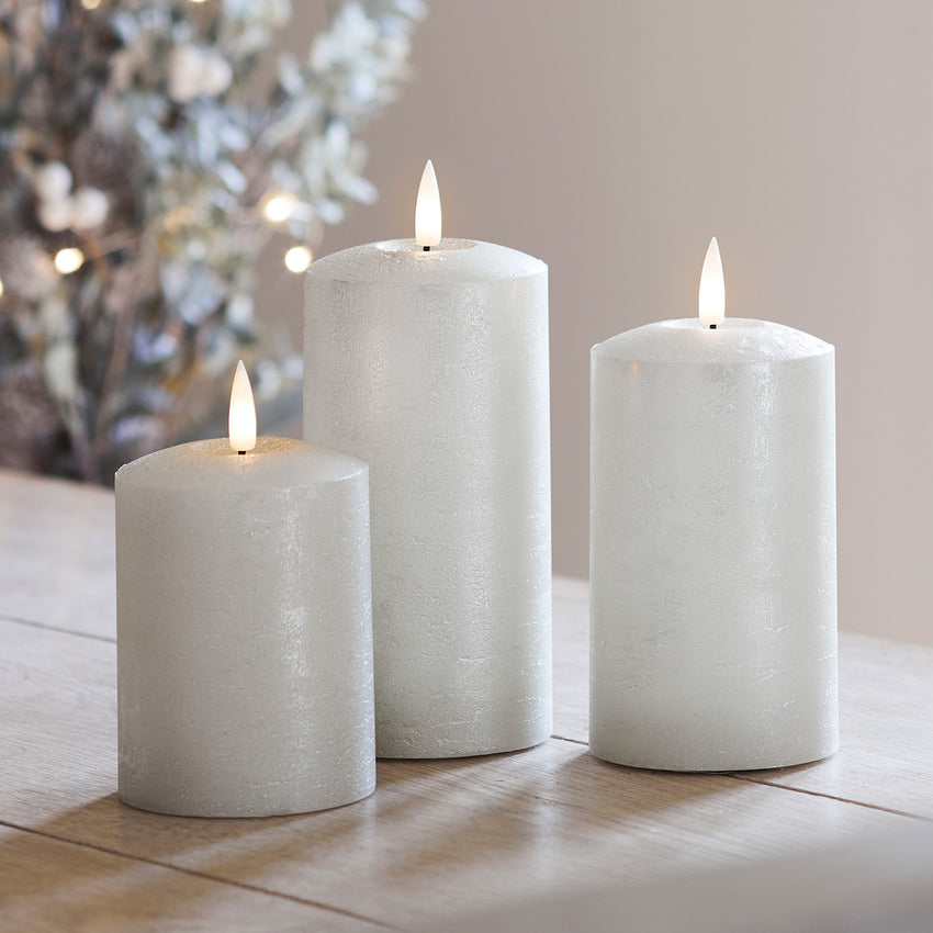 Champagne LED pillar candle trio on a table
