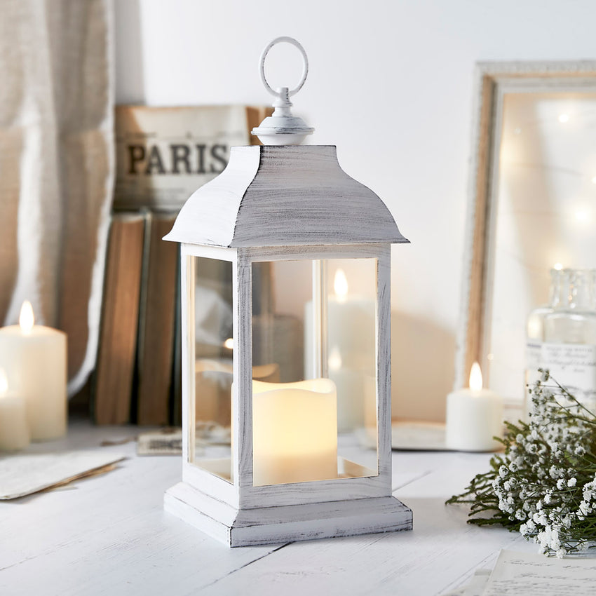 White indoor wedding lantern on the floor with wedding accessories
