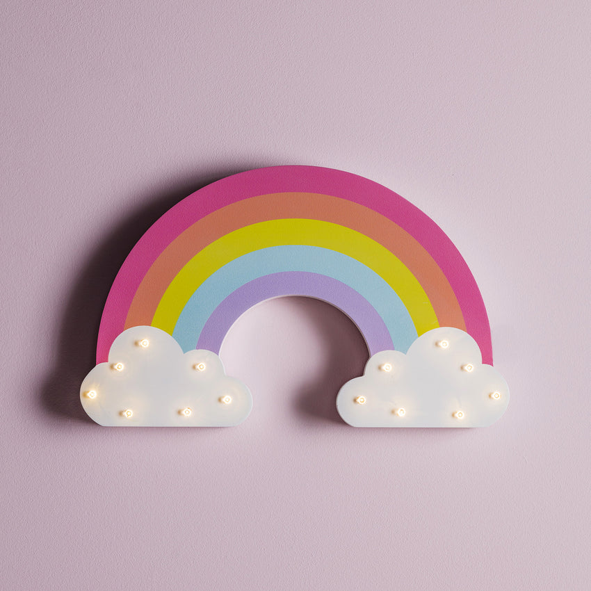 Children's rainbow wall light on a pink wall