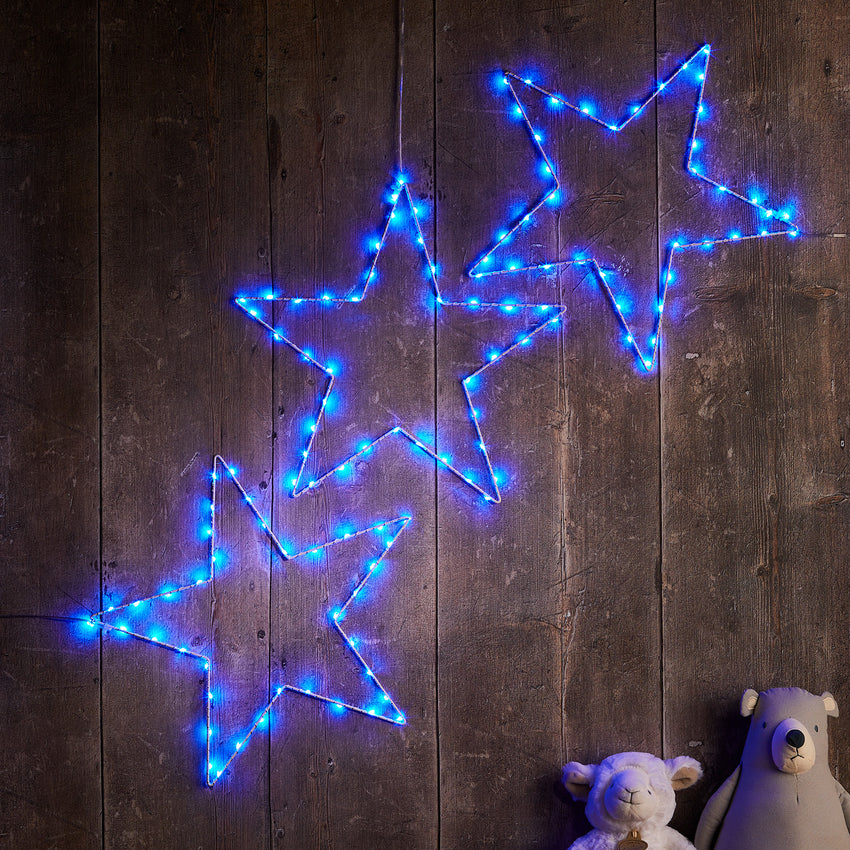 Trio of blue Osby star lights hooked to a wall