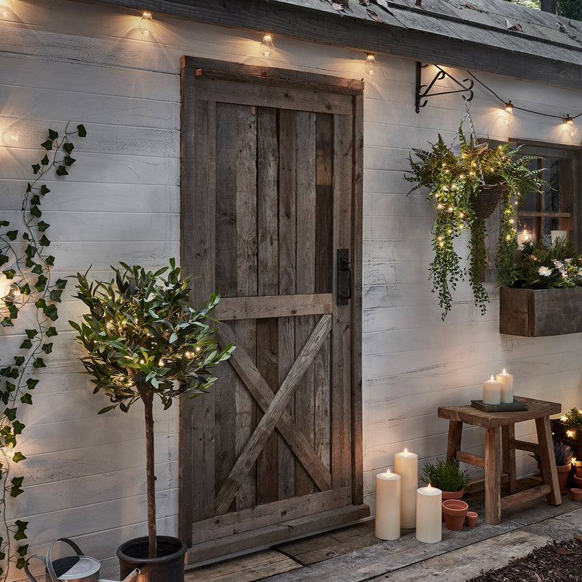 Fairy lights on mini outdoor tree outside cabin