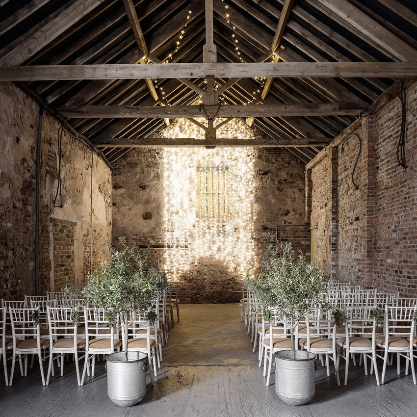 Barn wedding featuring festoon lights and light curtains