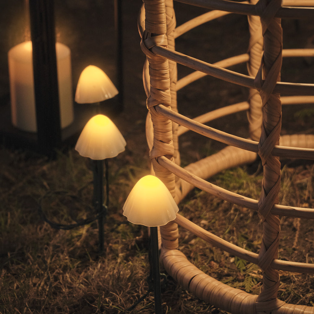 Mini mushroom stake lights next to a garden table