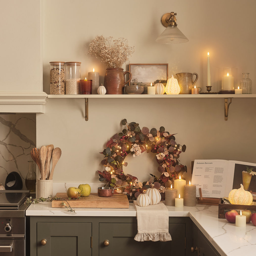 Kitchen decorated with pumpkins, LED candles, and an autumnal wreath