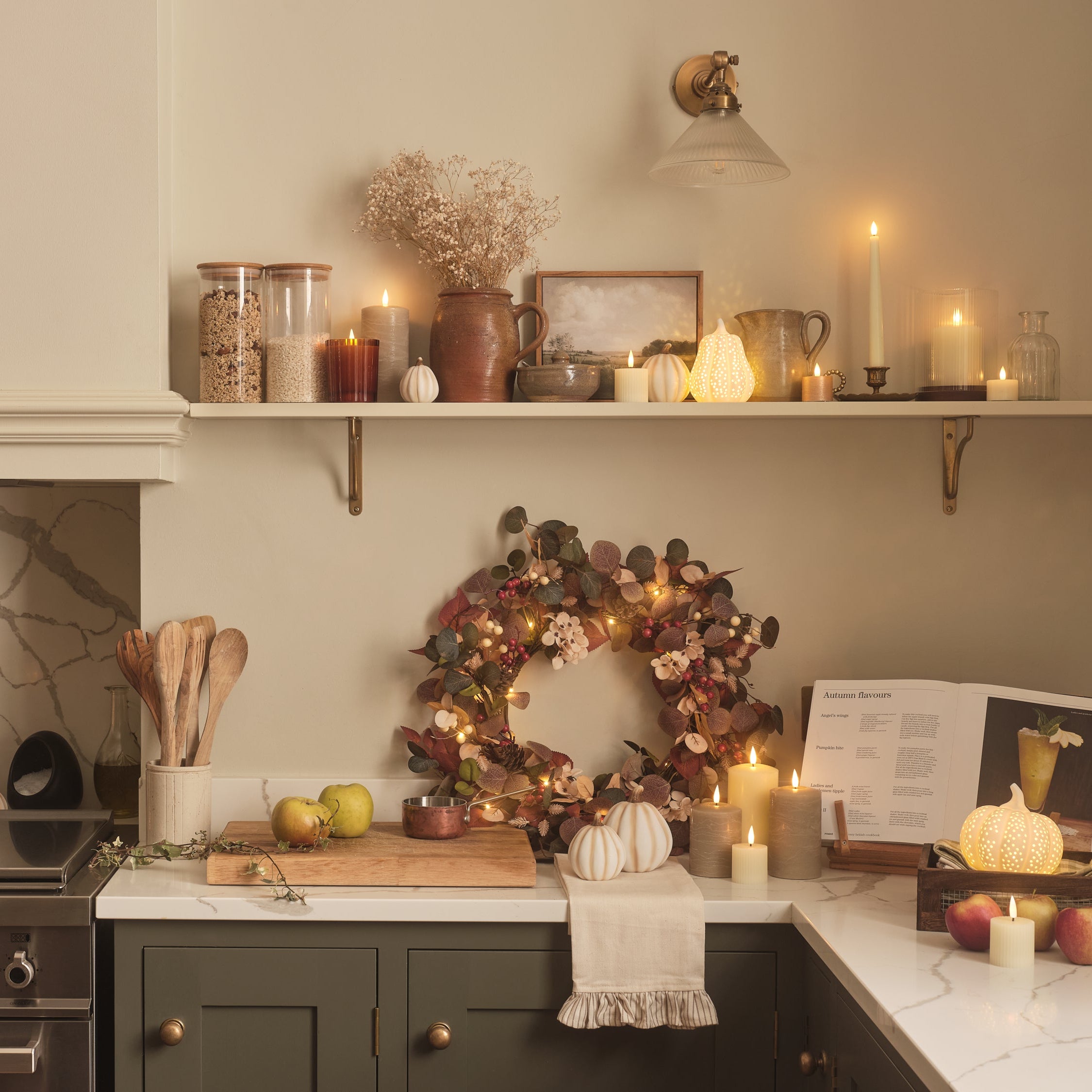 Kitchen decorated with porcelain pumpkins, led candles, and an autumn wreath