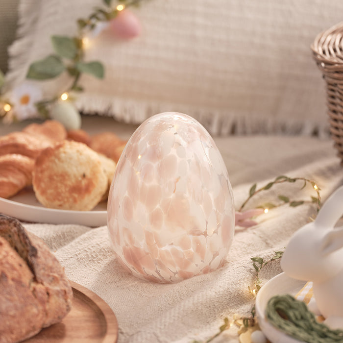 Confetti glass egg decoration on a picnic blanket