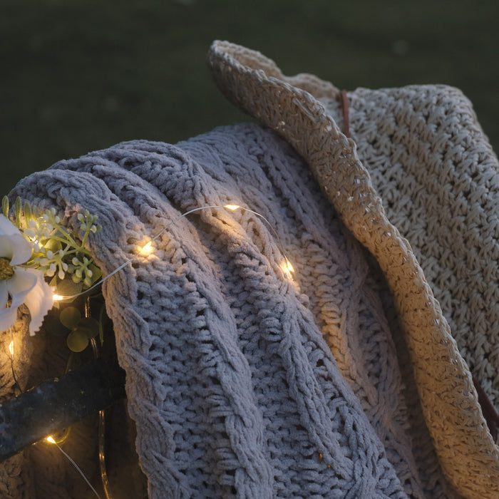 Bench with a blanket, hat and micro lights