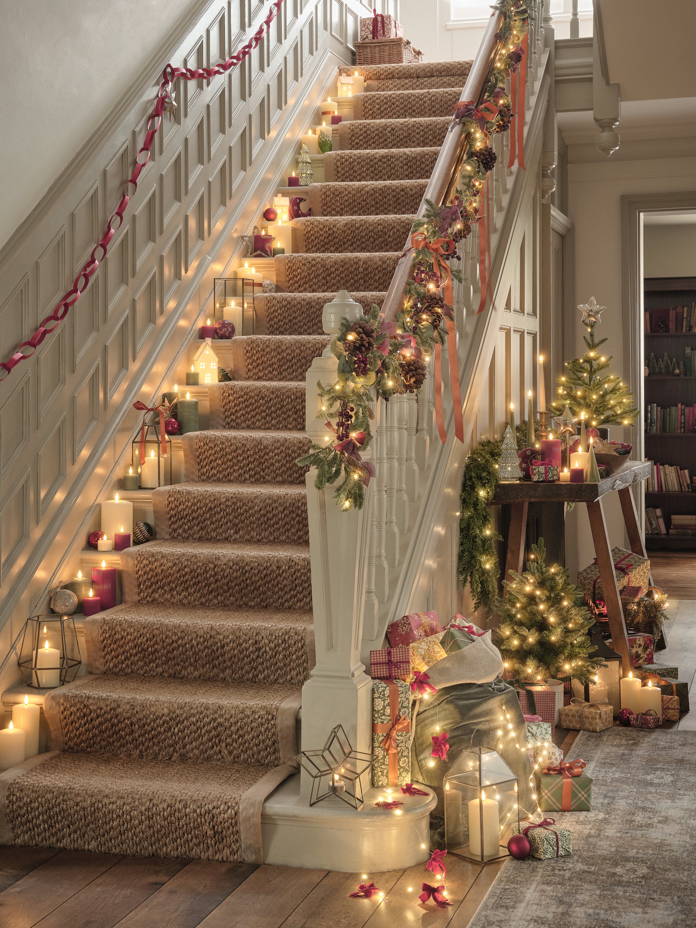 Staircase decorated with traditional Christmas lights and decorations