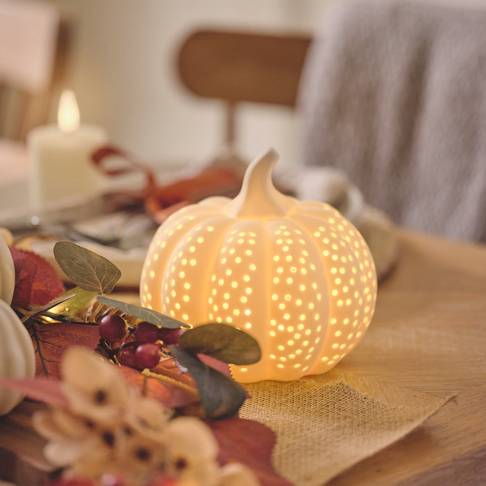 Porcelain light up pumpkin on an autumnal dining table