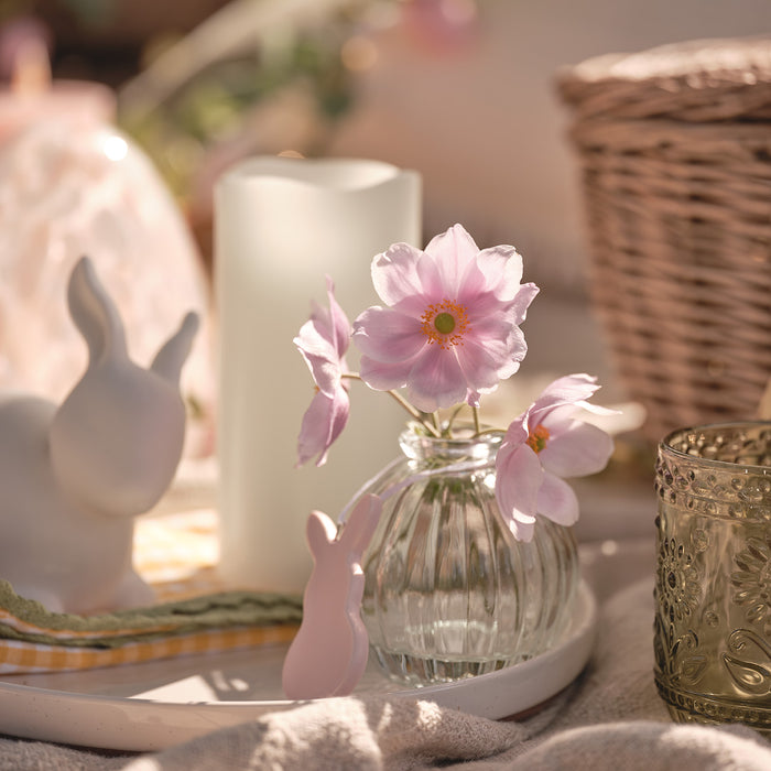 Vase of flowers on a picnic blanket