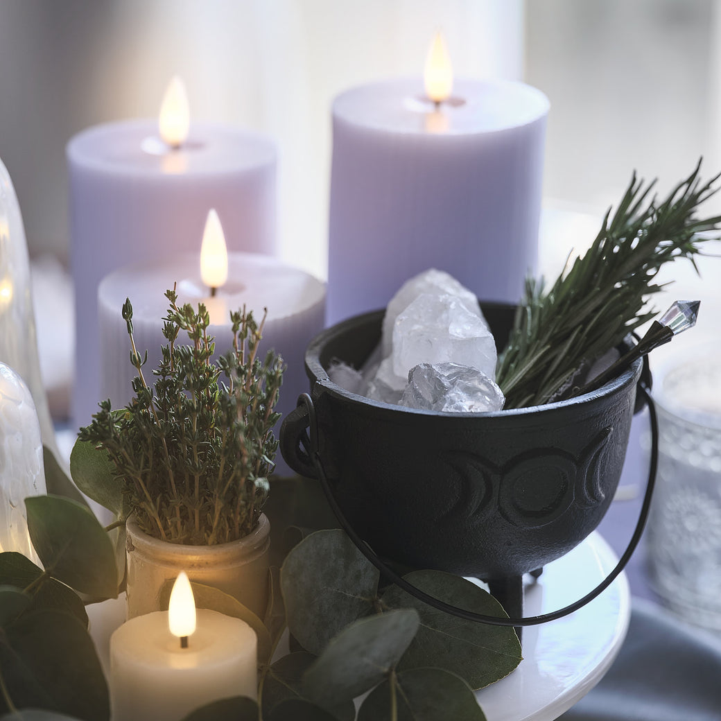 Halloween cauldron with herbs and crystals