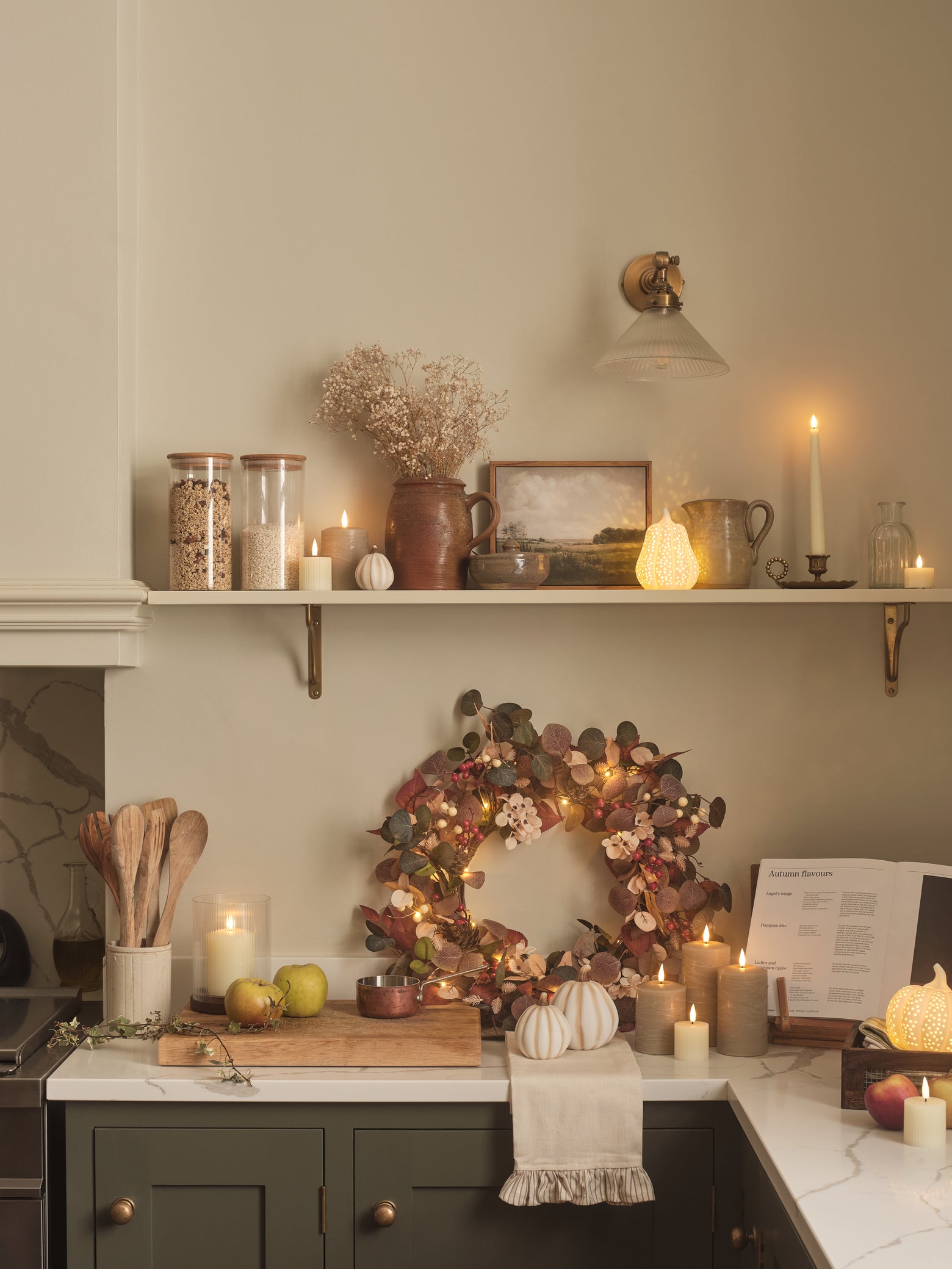 Kitchen decorated with pumpkins, LED candles, and an autumnal wreath