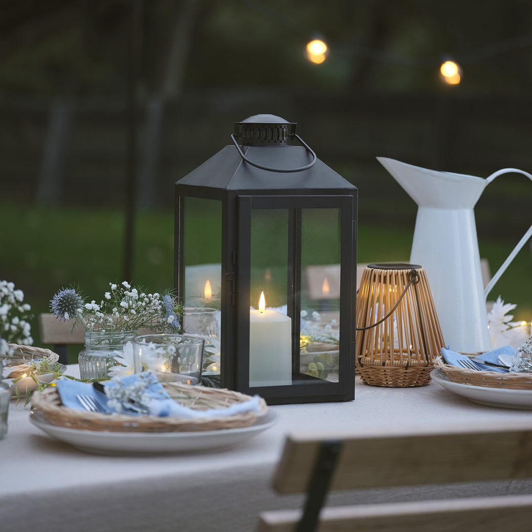 LED candle lantern on an outdoor dining table