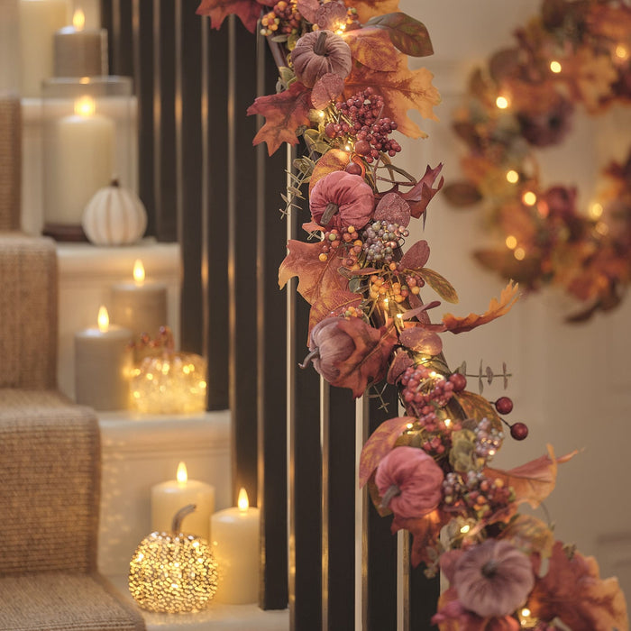 Luxury velvet pumpkin garland draped on a bannister