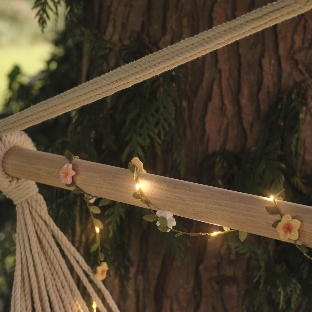 Micro flower garland wrapped around a garden chair