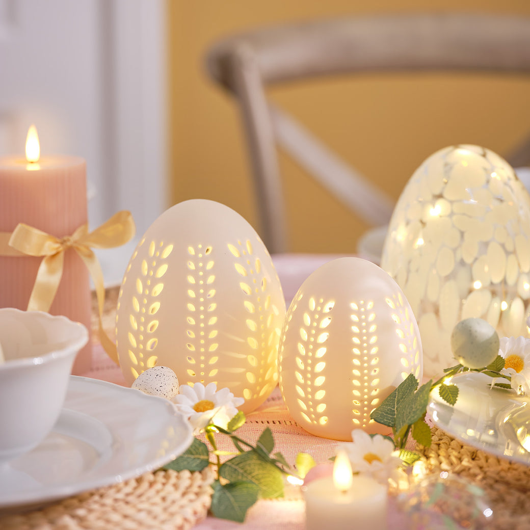 Pair of porcelain easter egg decorations on a table 