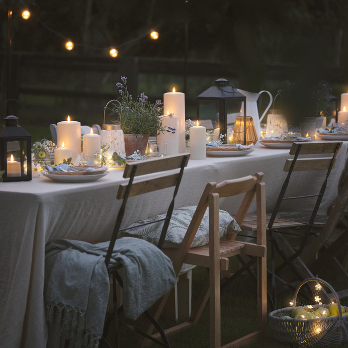 Outdoor dining table with LED candles and lanterns