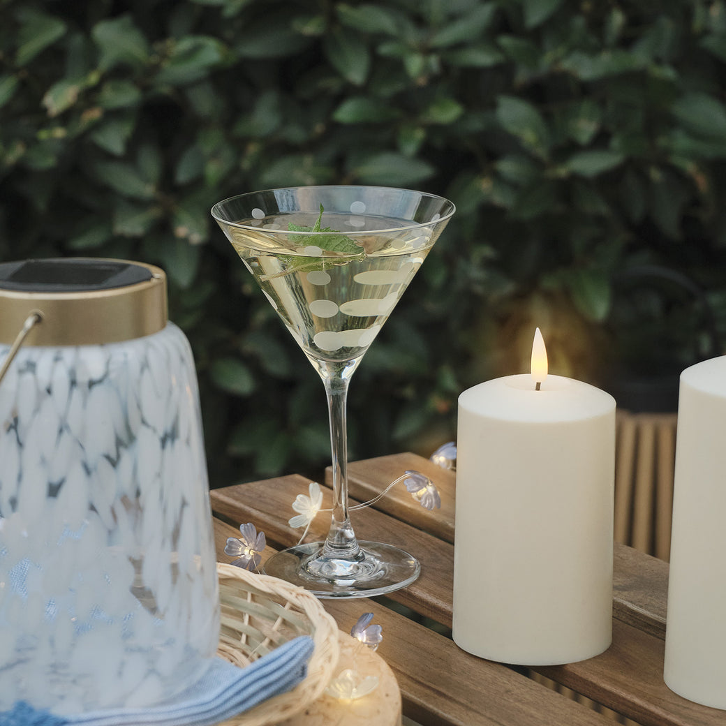 LED candle and drink on an outdoor table
