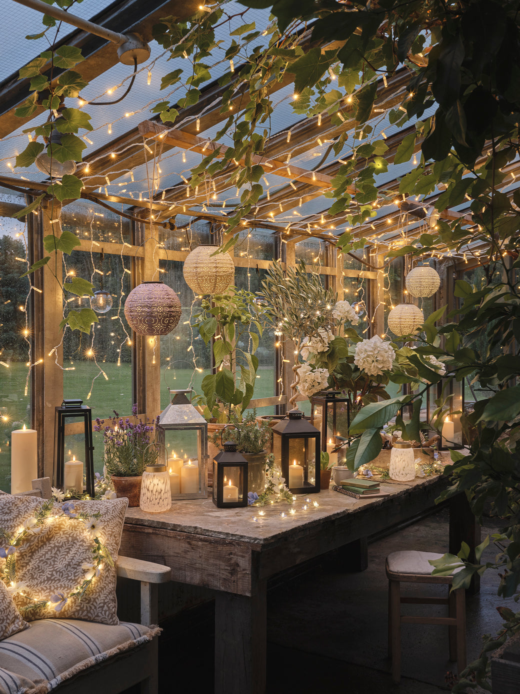Scandi styled greenhouse with lanterns and fairy lights