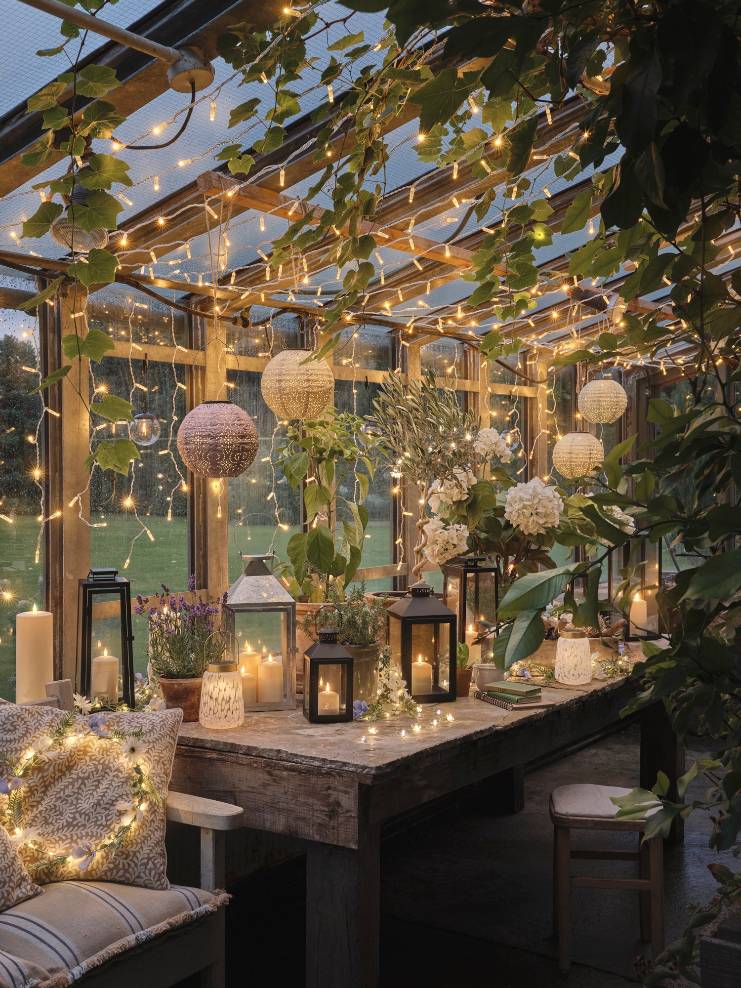 Scandi styled greenhouse with lanterns and fairy lights