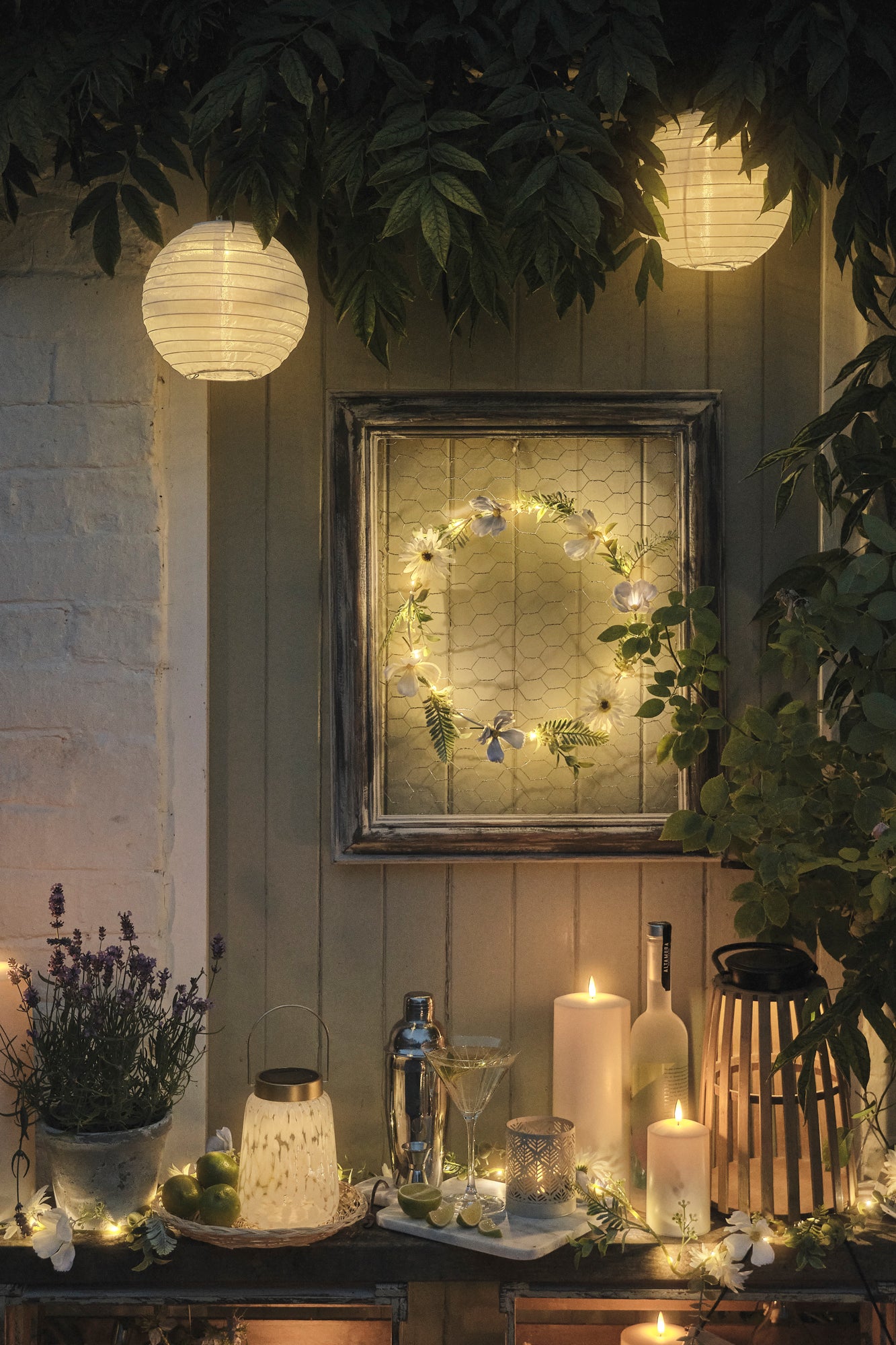 LED candles and lanterns light up an outdoor bistro area