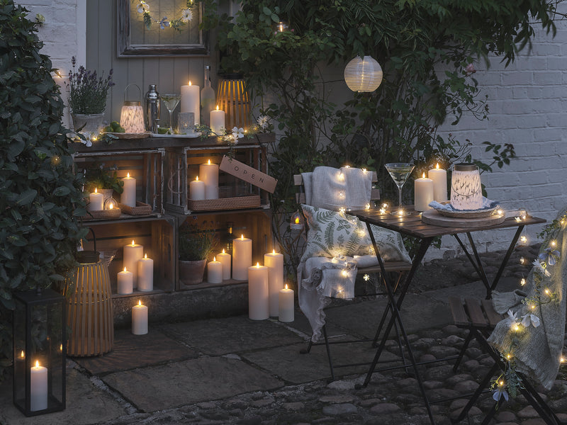 Outdoor bistro area lit with LED candles and lanterns