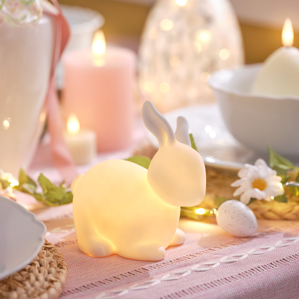 Lit up porcelain bunny on a dining table