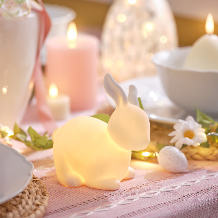 Lit up porcelain bunny on a dining table
