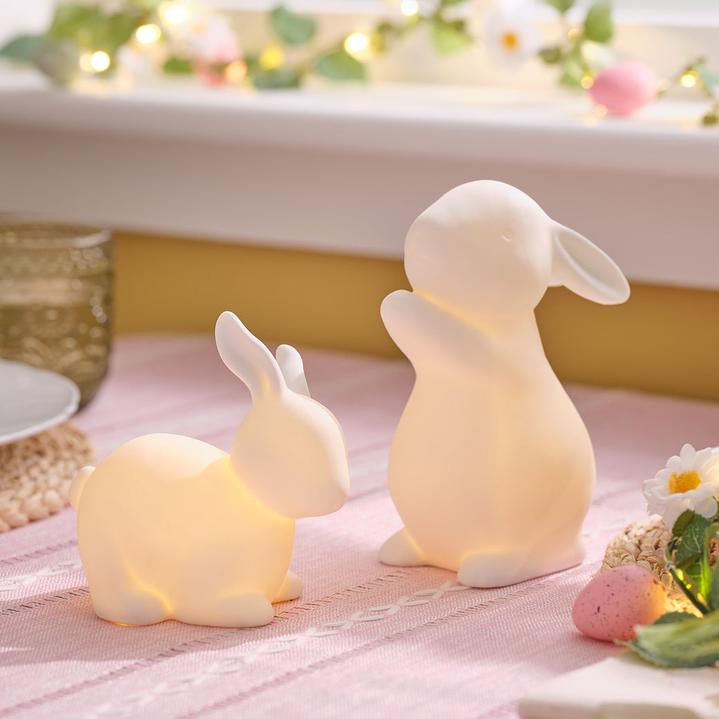 Set of 2 porcelain bunnies on a table