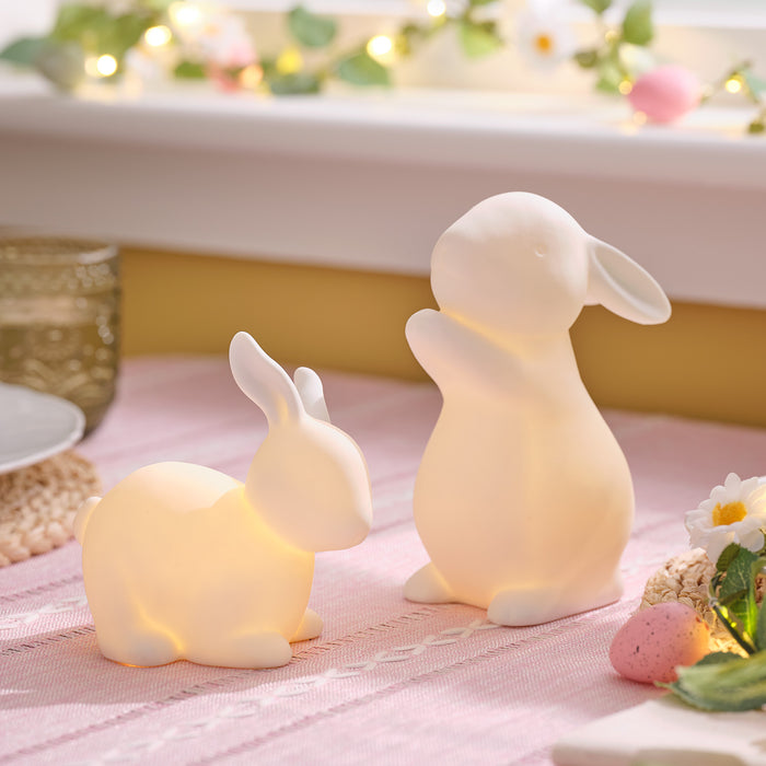 Set of 2 porcelain bunnies on a table