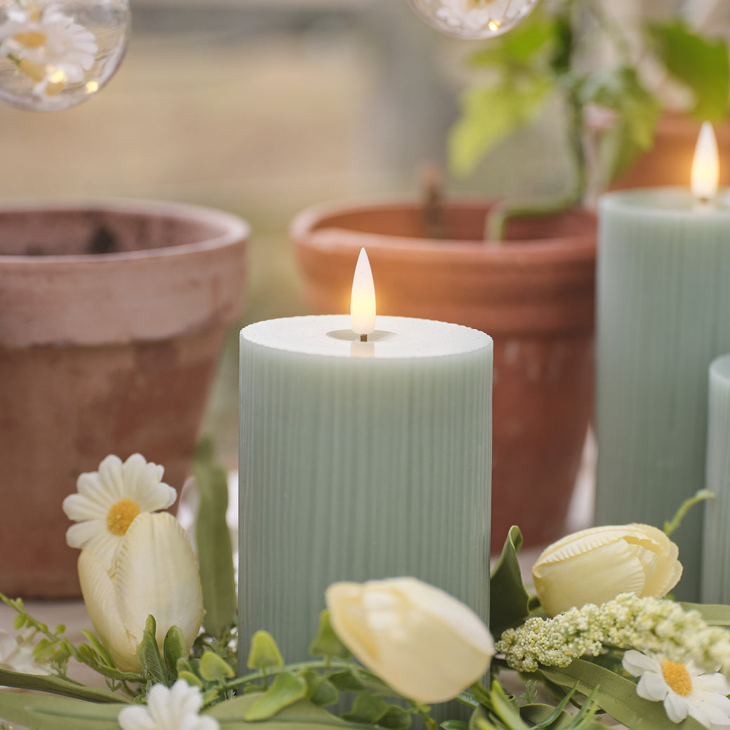 Green LED candle with a daisy and tulip candle holder