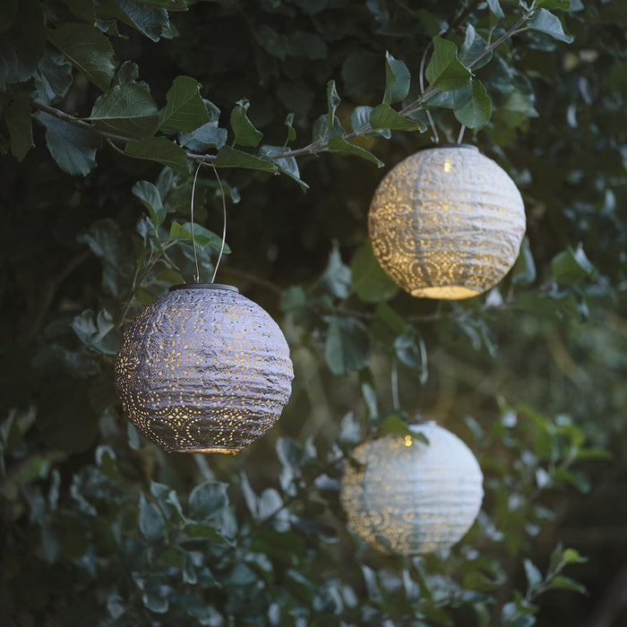 3 tyvek lanterns hanging from tree branches