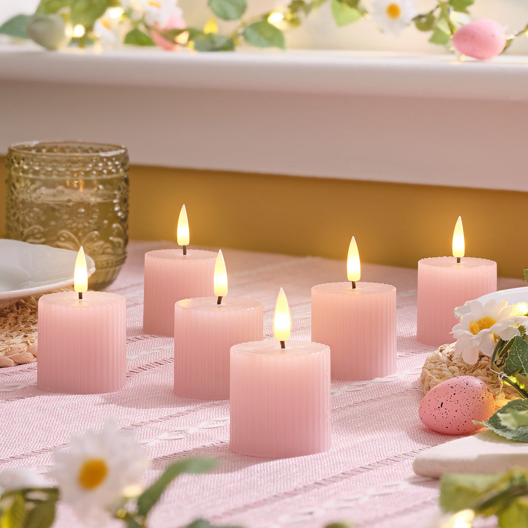 Small pink LED candles on a table