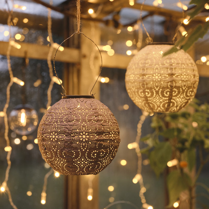 2 Tyvek Scandi solar lanterns hanging in a greenhouse