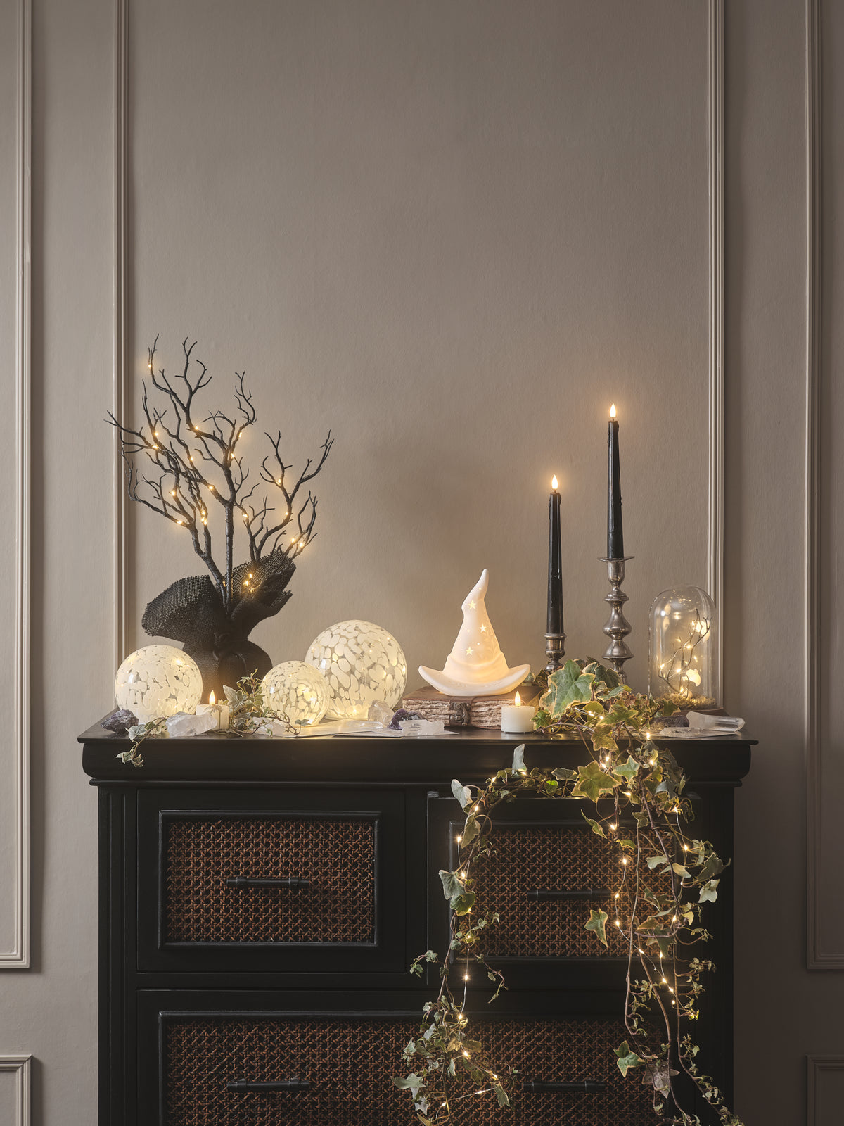 Cabinet decorated with LED candles and Halloween decorations