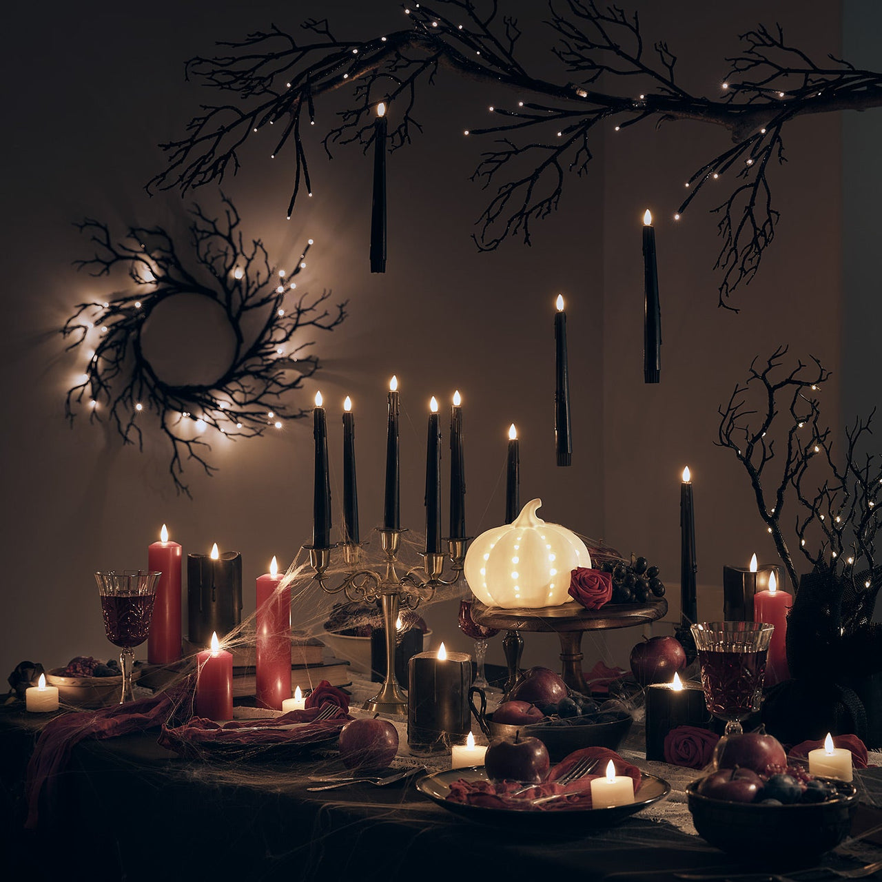 Spooky-halloween-dining-table-setup-with-LED-candles-pumpkins-wreath-garland_3ce6aaad-226b-4079-8e7e-b9a598395c16.jpg