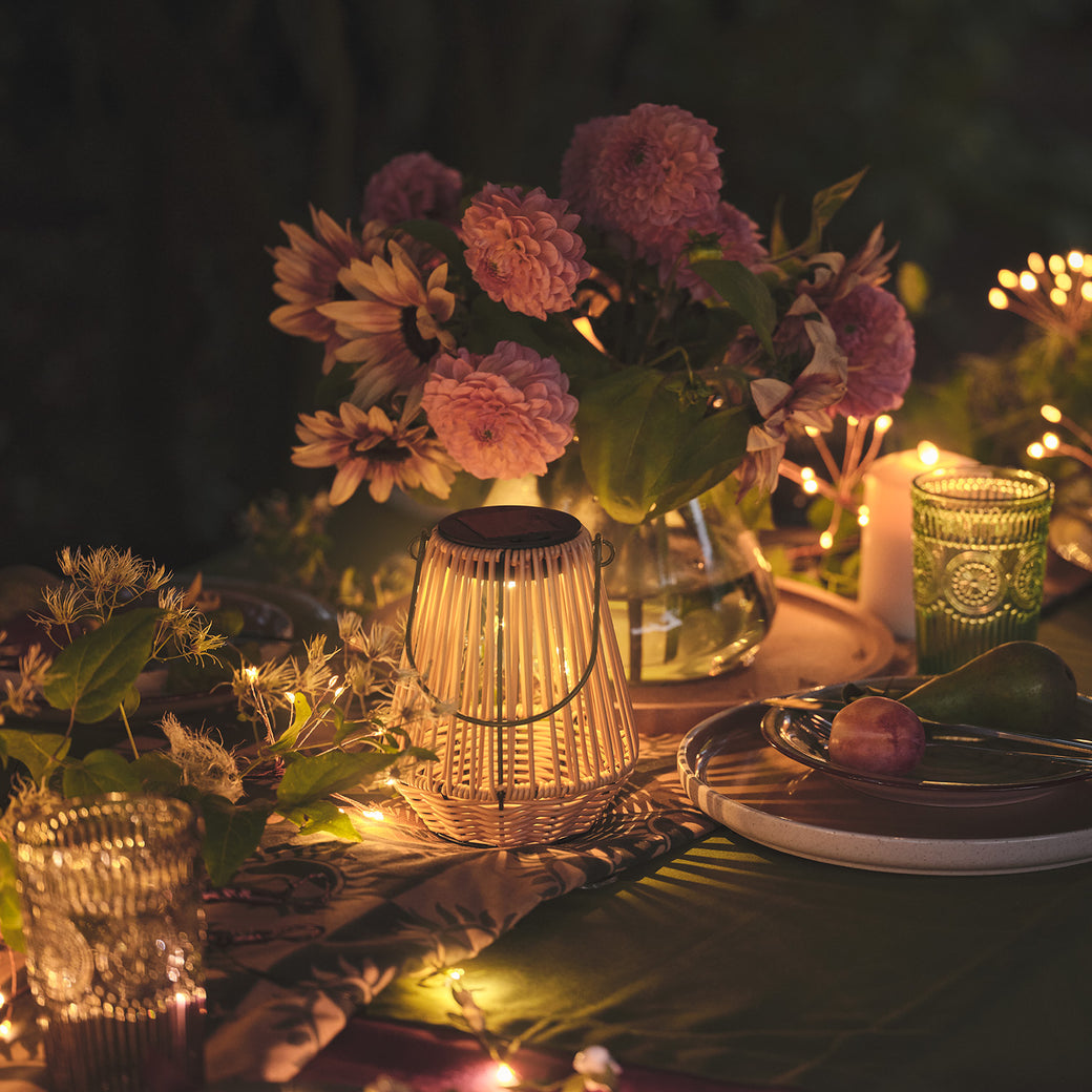 Solar lantern on an outdoor dining table at night