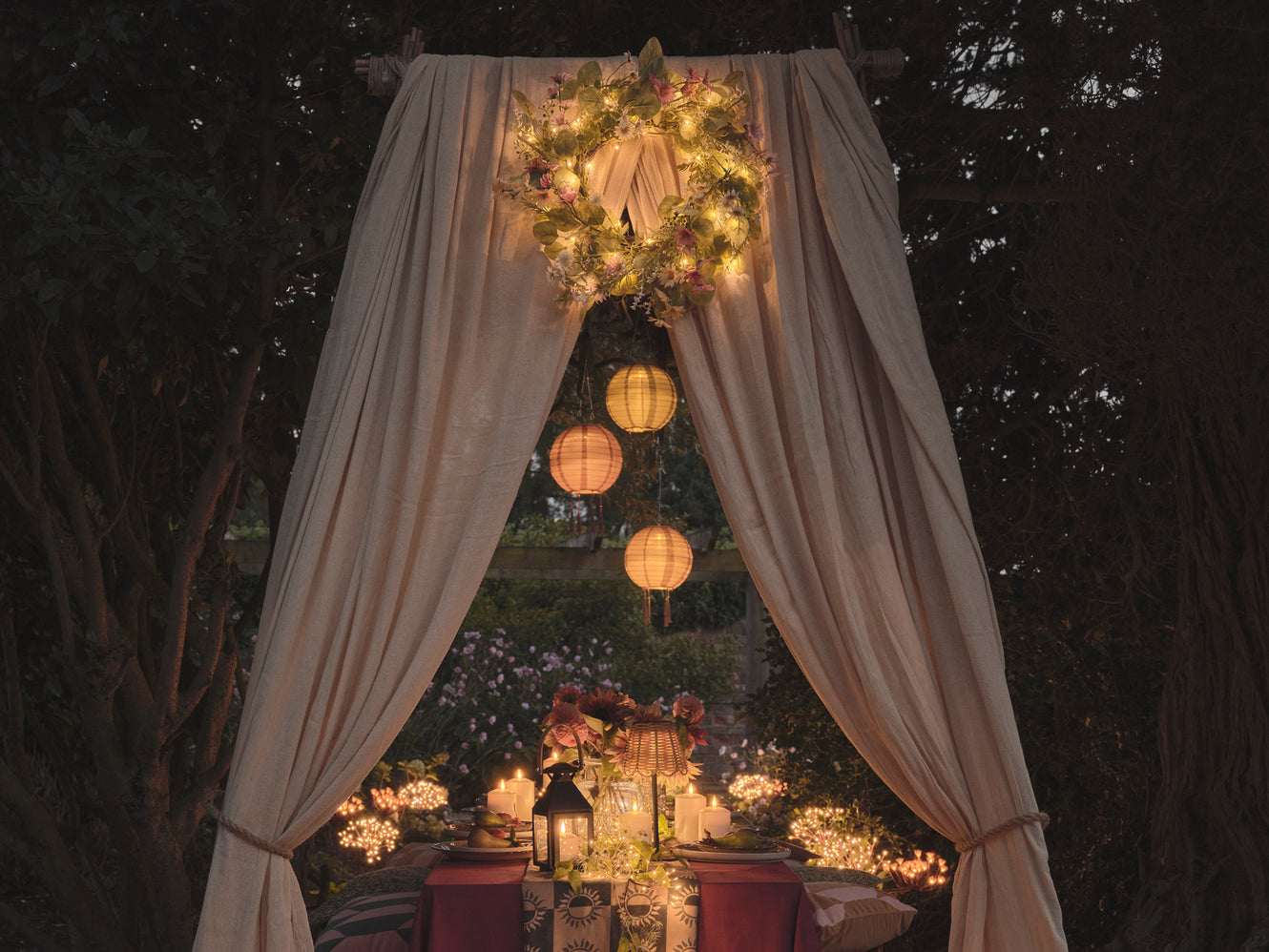 Outdoor dining table with lanterns and LED candles.