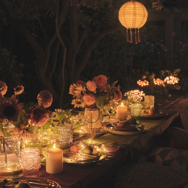 Outdoor dining table with LED candles and solar lights