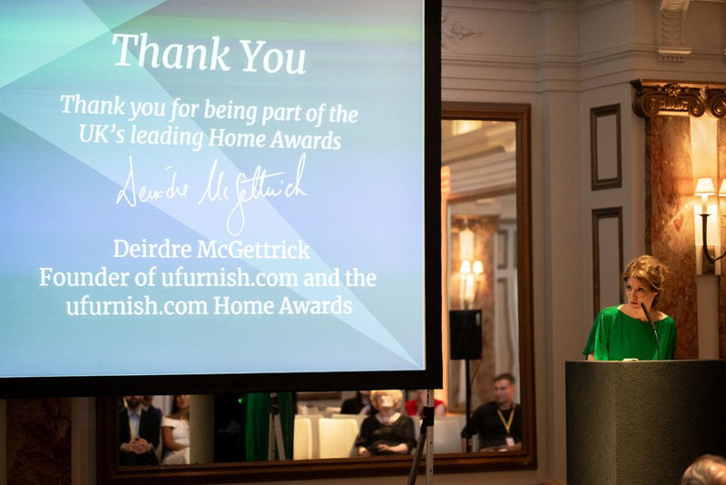A woman presenting at the front of a room