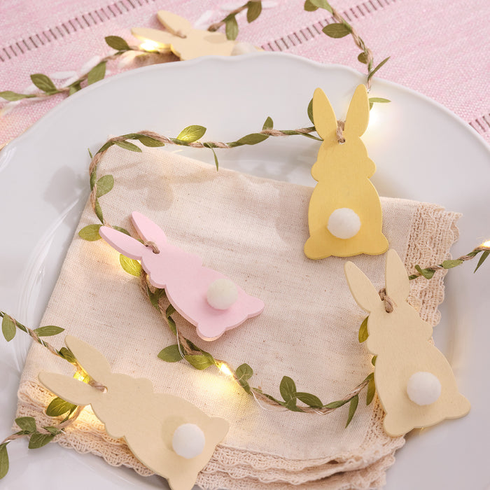 Wooden bunny garland draped over a place setting