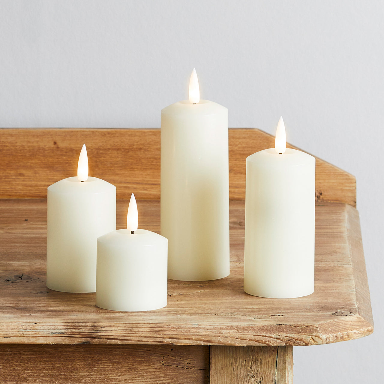 4 TruGlow® Ivory Slim Pillar Candles