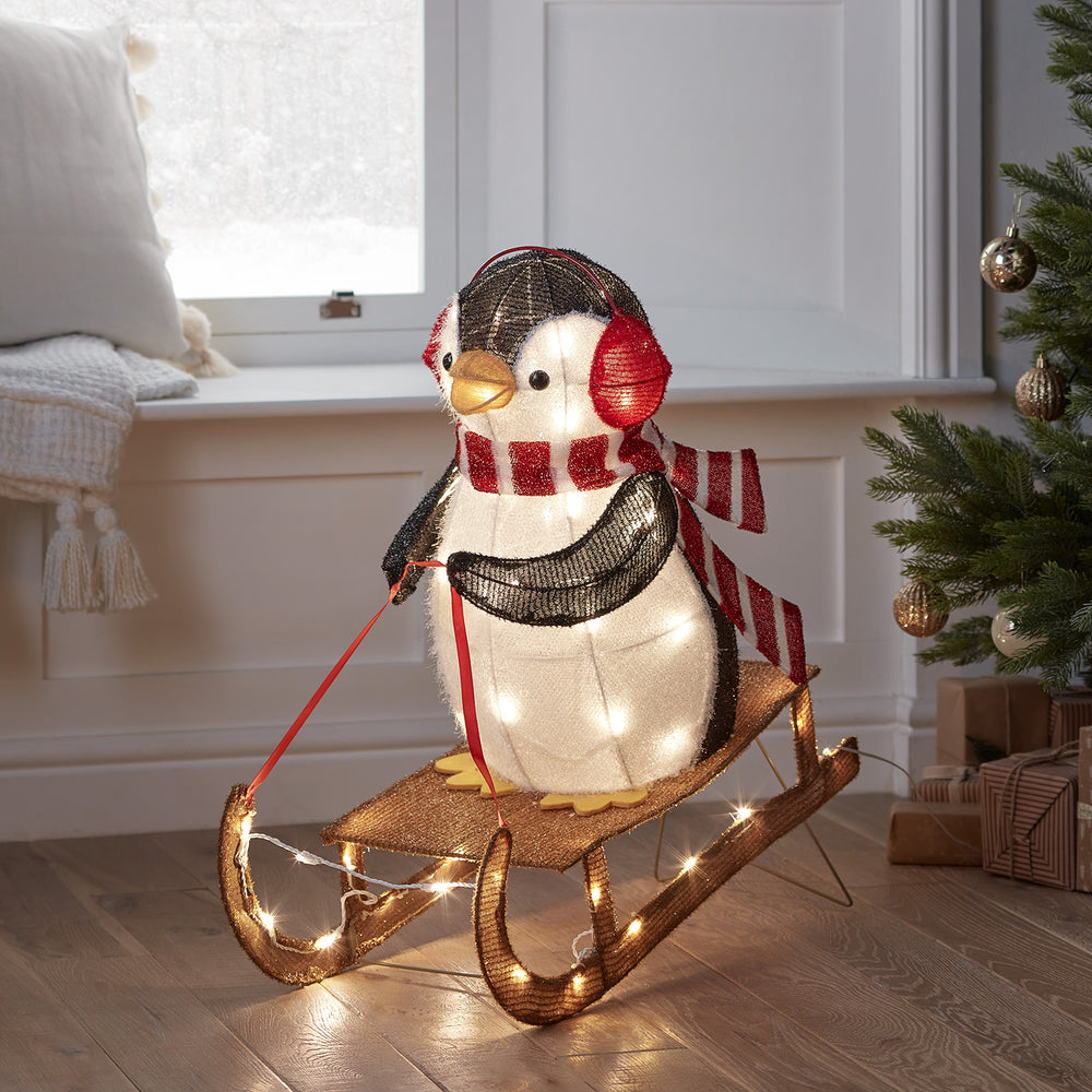 Sledging Penguin Christmas Figure
